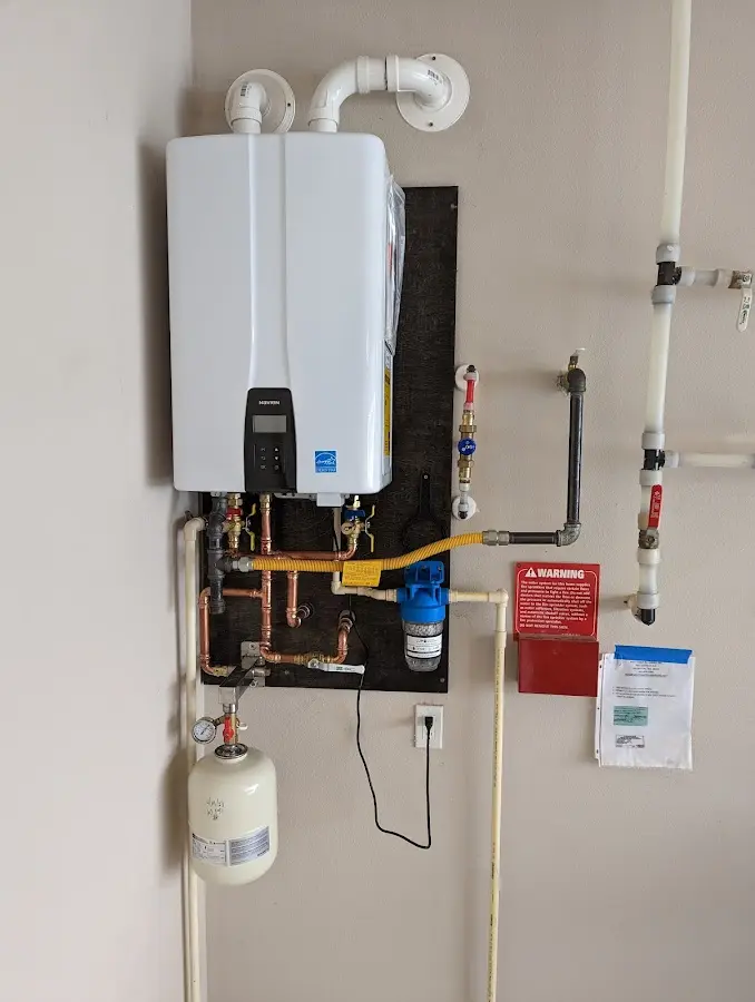 Professional plumber installing copper piping in a Alton home